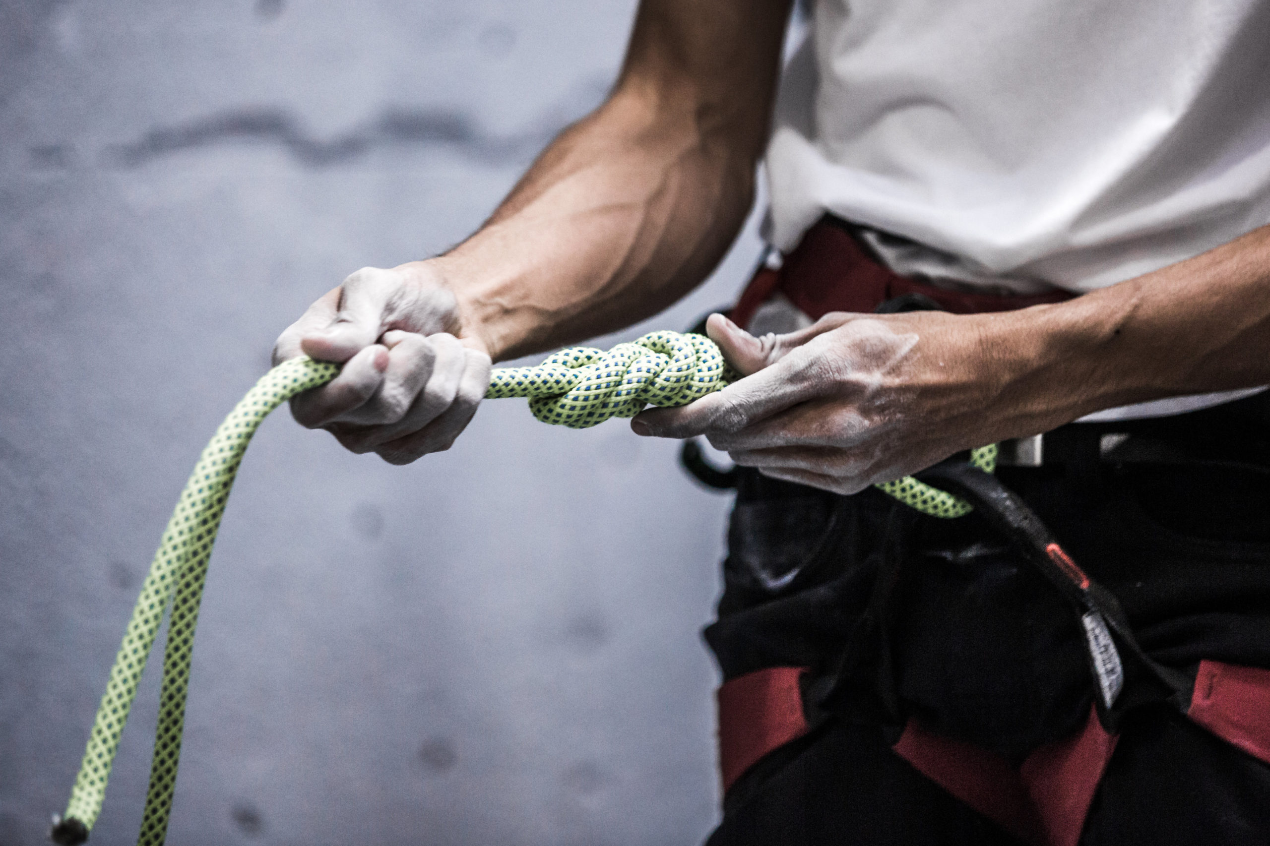a-rock-climber-holds-out-knotted-rope